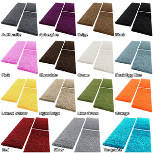 A color-options grid showing multiple pairs of shaggy rectangular floor mats in different colors, each labeled with a name such as Anthracite, Aubergine, Beige, Black, Pink, Chocolate, Cream, Duck Egg Blue, Lemon Yellow, Light Beige, Lime Green, Orange, Red, Silver, and Turquoise on a white background.