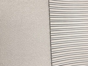Close-up of a textured light gray surface next to a white ribbed or slotted material, showing material/color options.