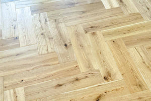 Top view of natural oak herringbone flooring