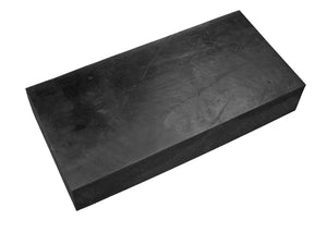 A rectangular black sharpening stone or honing steel block with a matte textured surface, shown at an angle on a plain white background.