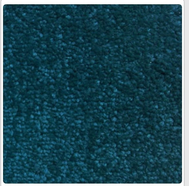 A close-up texture shot of a dark teal blue carpet or fabric swatch, framed with a thin white border.