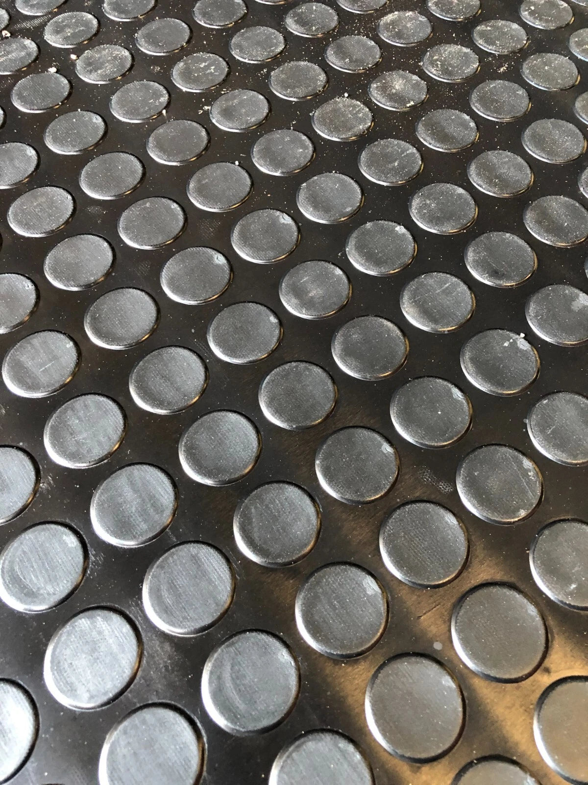 Close-up of a metal surface with circular indentations