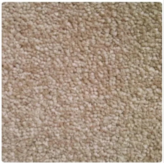 A close-up texture shot of a beige carpet or fabric with a short pile and mottled light and medium beige tones.