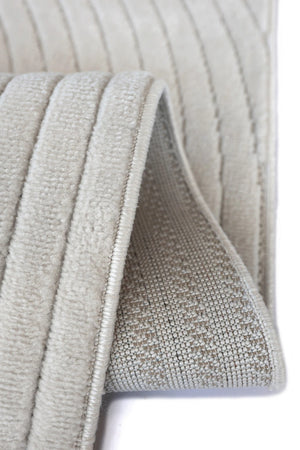 Close-up of a light beige ribbed fabric product, showing the textured woven surface and folded edges against a white background.