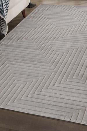 Gray geometric patterned rug on a wooden floor