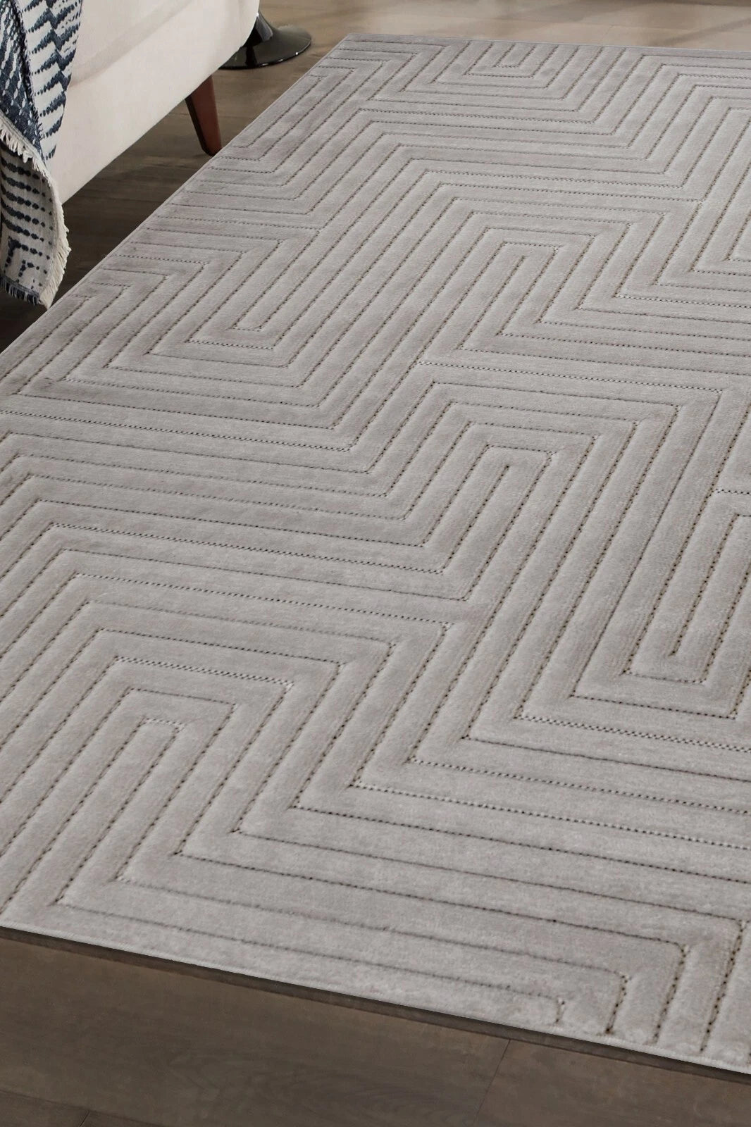Gray geometric patterned rug on a wooden floor