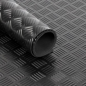 Roll of black textured rubber matting on a matching background