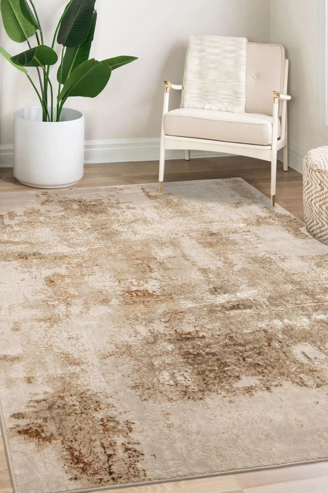 Beige and brown patterned rug in a room with a chair and plant.