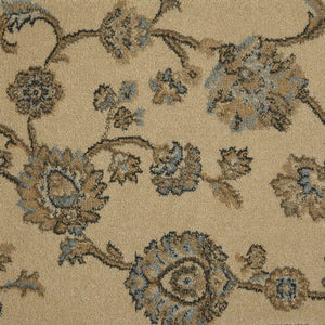 Close-up of a woven floral rug or fabric pattern in beige with brown and light blue motifs.