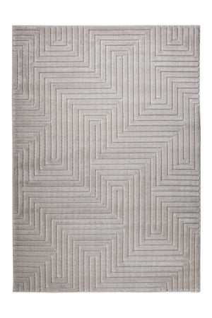A rectangular area rug with a modern geometric pattern of raised, parallel lines forming a maze-like zigzag design in light gray and beige tones.