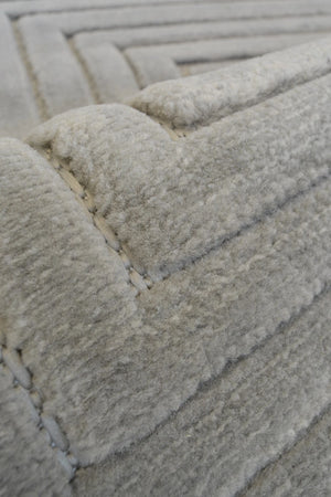Close-up of a textured gray rug with geometric pattern