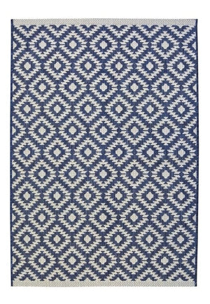 A rectangular woven rug with a repeating geometric diamond pattern in navy blue and off-white, featuring a matching off-white border.