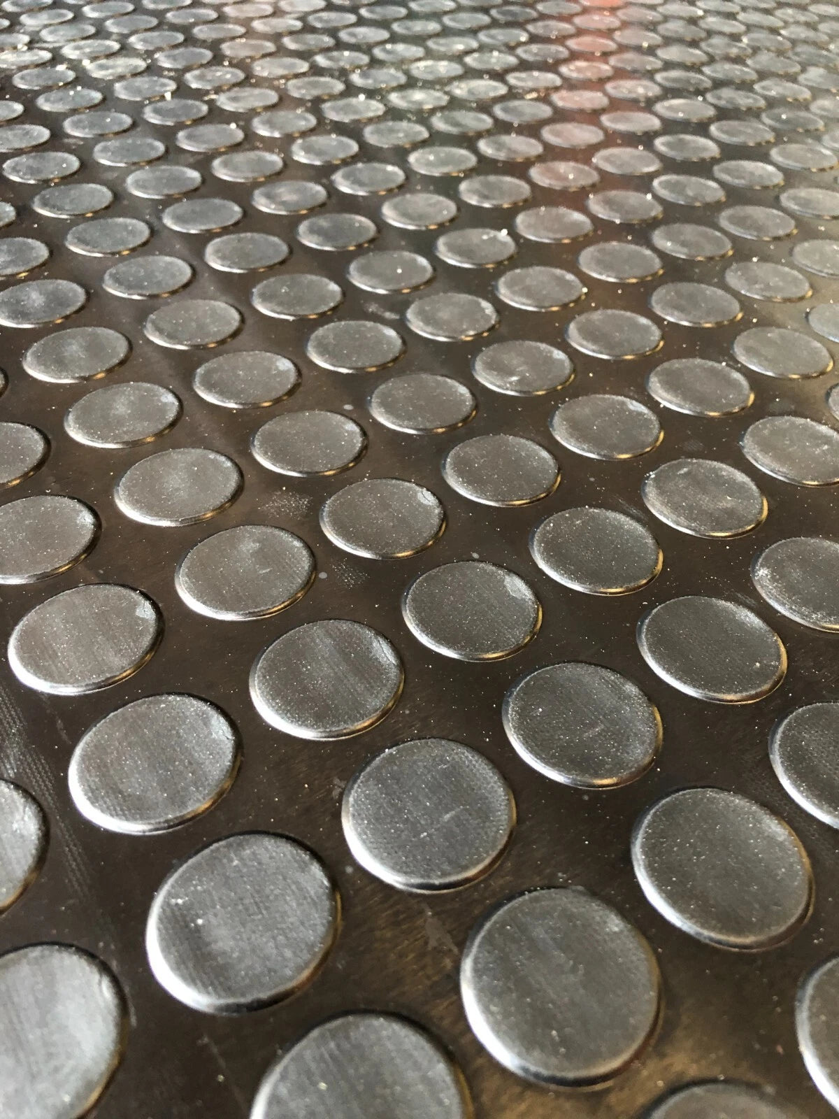 Close-up of a metal grid with circular patterns