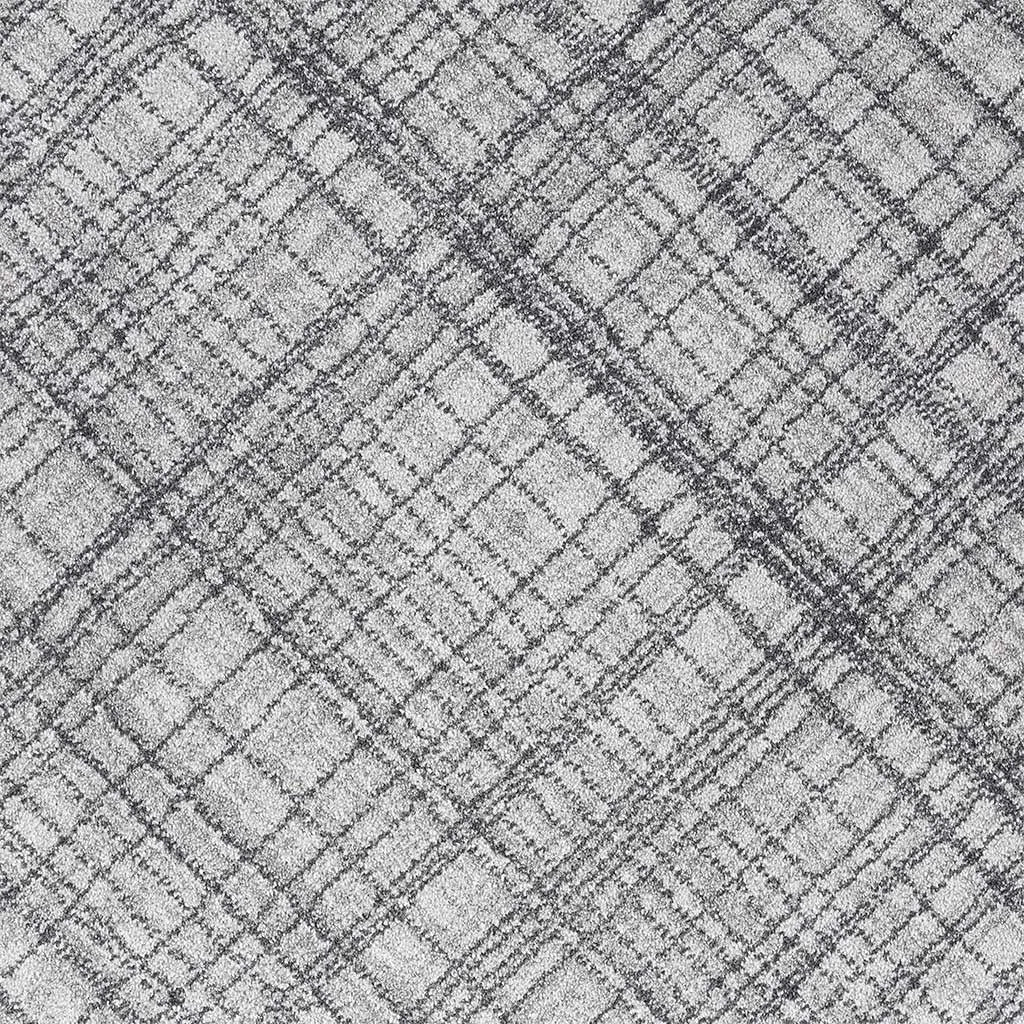 A close-up of a gray and white textured fabric with a subtle plaid pattern.