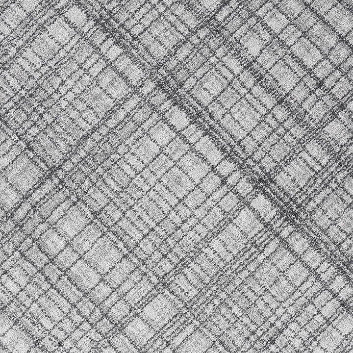 A close-up of a gray and white textured fabric with a subtle plaid pattern.