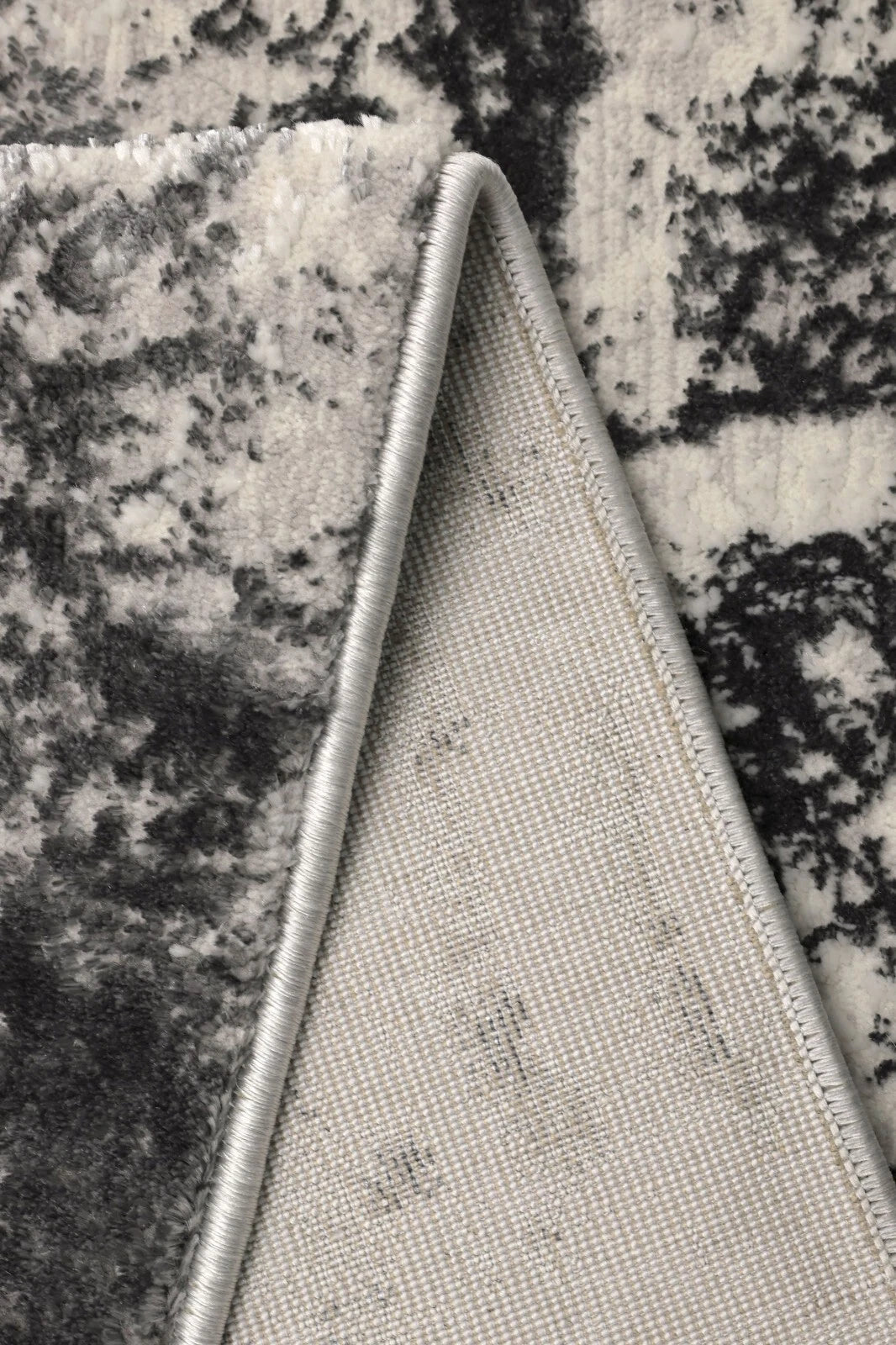 Close-up of a textured fabric triangle on a granite surface