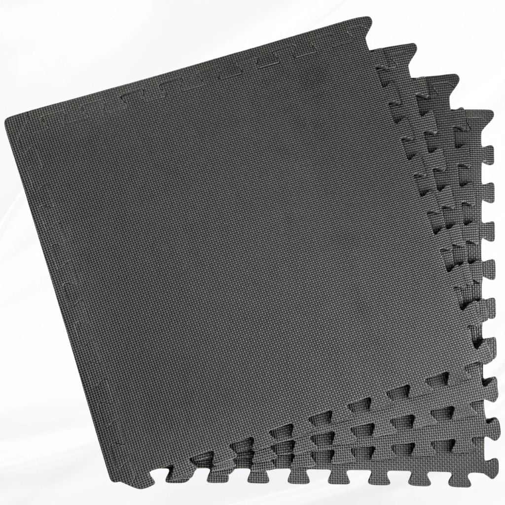 Top angle view of neatly stacked square soft EVA foam floor tiles for kids play or home gym setup.