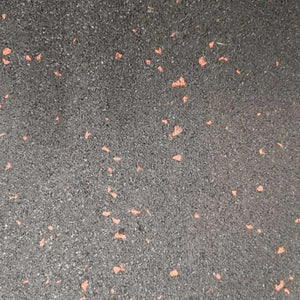 Top view texture of a black fine crumb rubber gym mat surface highlighting the burnt orange fleck design.