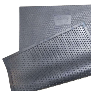 A luxury black rubber stable mat displaying the textured diamond grip top layer alongside its raised bottom drainage studs.