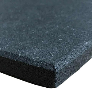 A close-up corner view of a heavy-duty black rubber gym mat floor tile showcasing its dense, shock-absorbing granular crumb texture.
