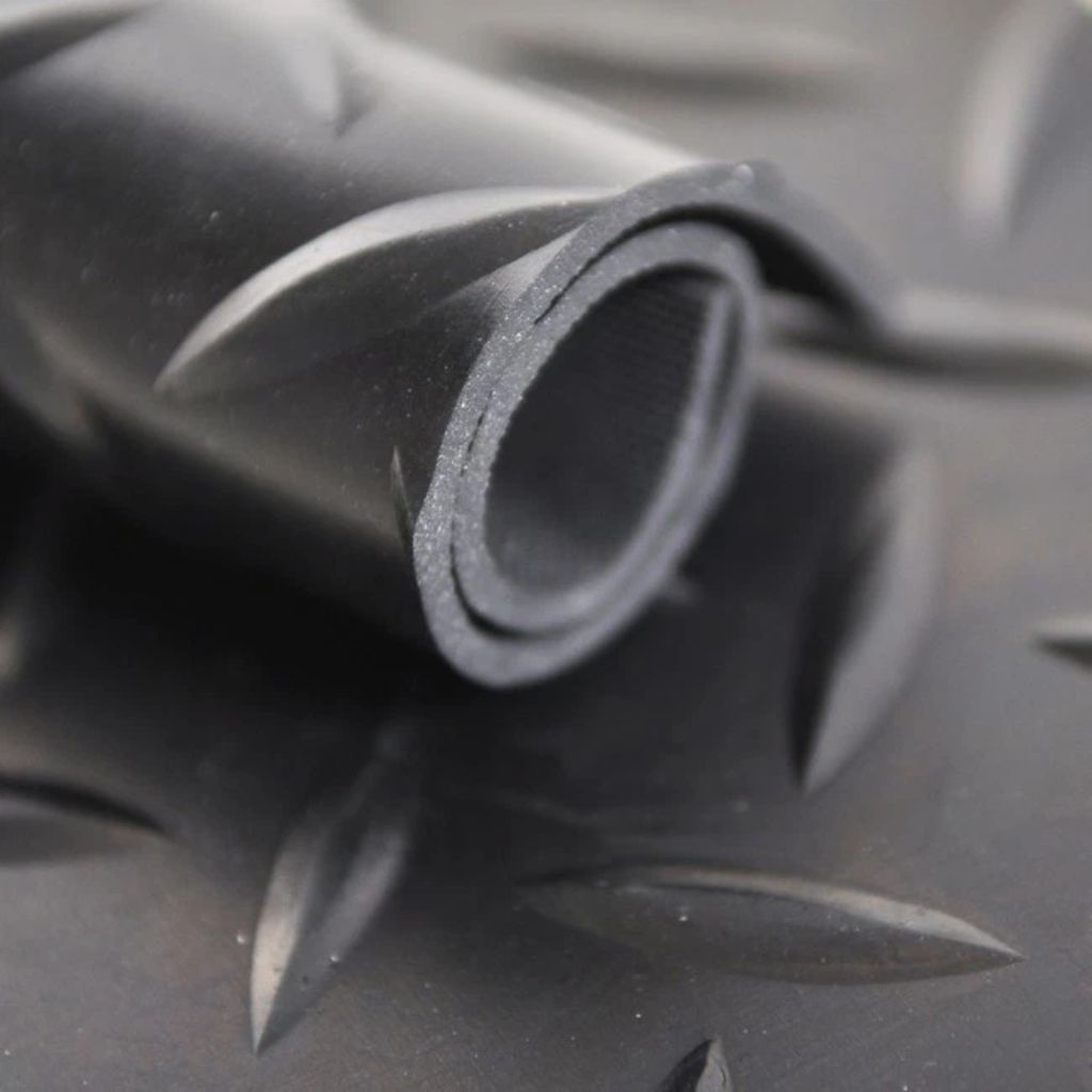 Close-up of a roll of black rubber sheeting with a textured surface.