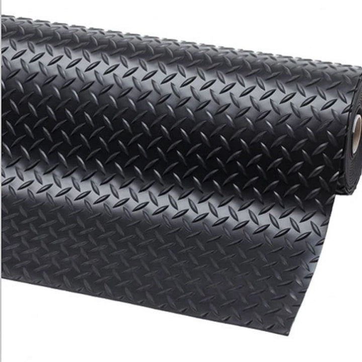 A black diamond plate textured mat, partially rolled up, shown on a plain white background.
