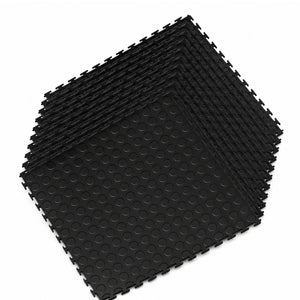 A stack of black interlocking foam floor mats with a raised circular grip texture, shown on a plain white background.