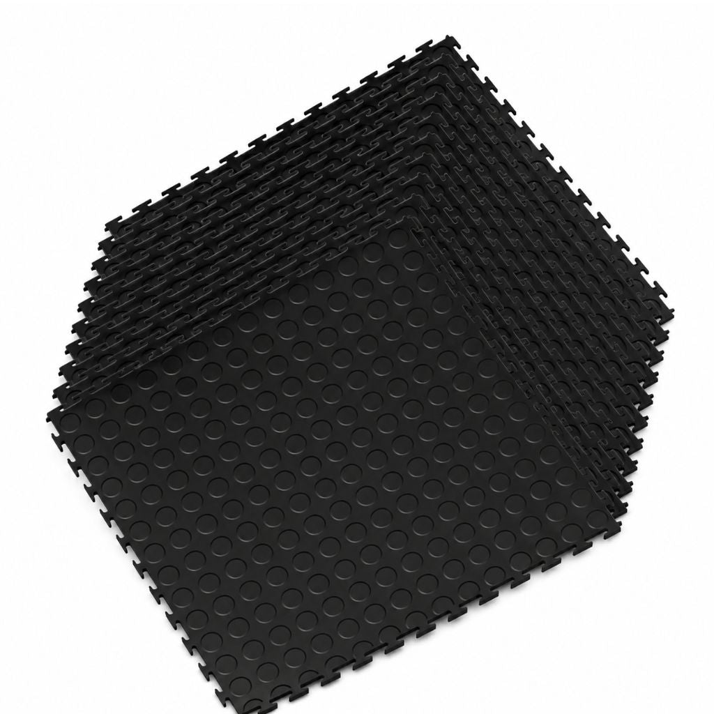 A stack of black interlocking foam floor mats with a raised circular grip texture, shown on a plain white background.